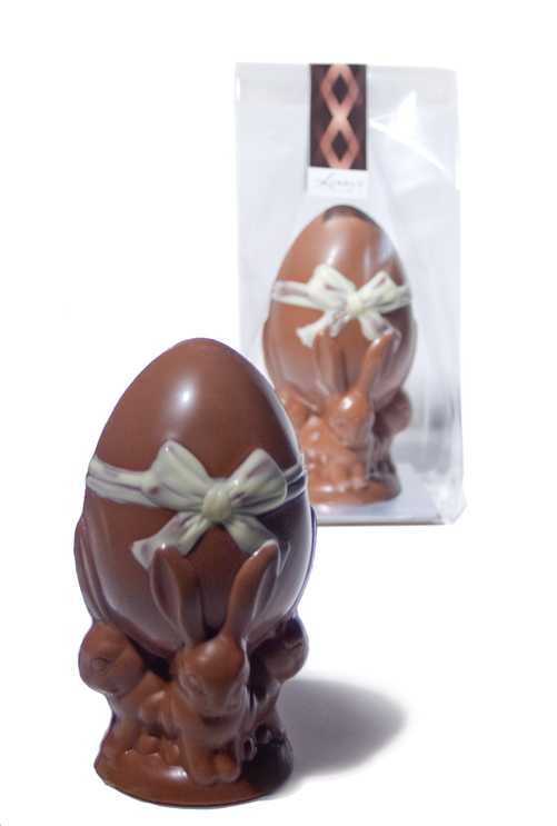 bunnies holding an Easter egg with a white painted bow